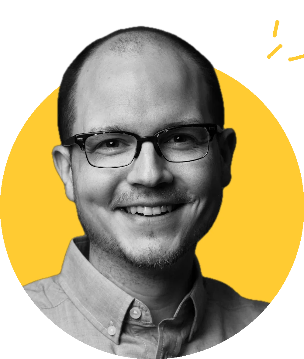 Dave Steininger, smiling, in glasses and a button-down shirt